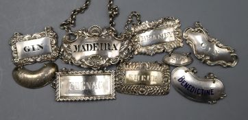 Eight assorted 19th and 20th century silver wine labels and a silver condiment label.