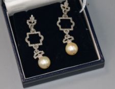 A pair of 1920's/1930's white metal, diamond and cultured pearl set openwork drop earrings, 48mm.