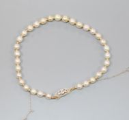 A natural pearl and yellow metal spacer set bracelet with diamond set clasp, with Gem & Pearl