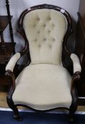 A Victorian carved elbow chair