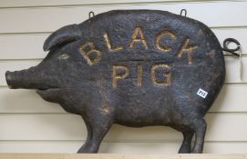 A carved wood 'black pig' tavern sign 85cm long