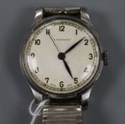 A gentleman's 1940's steel cased Longines manual wind wrist watch, on associated flexible strap.