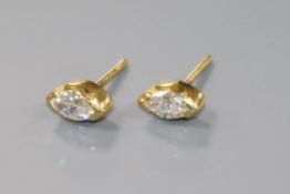 A modern pair of 18ct gold and solitaire marquise diamond set ear studs.