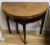 A George III mahogany demi-lune triple top tea and card table