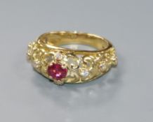 A French 18ct yellow metal, ruby and diamond pierced dress ring, size L.