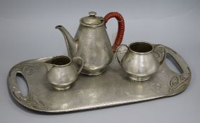 A Tudric pewter tray and a Tudric pewter three piece teaset tray 45cm wide
