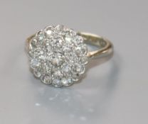 A mid 20th century 18ct white gold, platinum and diamond circular cluster ring, size L.