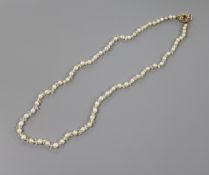 A single strand cultured pearl necklace with paste spacers and early 20th century yellow metal,