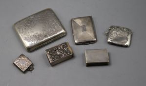 A silver cigarette case, a silver stamp holder, silver vesta case, two match sleeves and one other