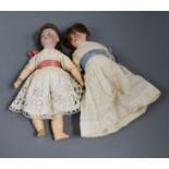 A Herman Steiner boy doll and a Simon and Halbig girl doll with pierced ears, open mouth, original