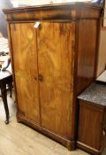 A Continental walnut two-door wardrobe W.105cm