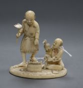 A Meiji period carved ivory okimono modelled as a fisherman and his son