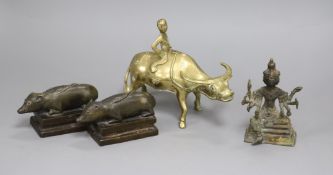 A pair of Nepalese bronze figures, a bronze bodhisattva and a brass buffalo group