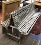 A mid 20th century two-sided slatted garden bench