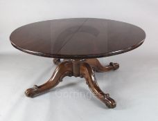A large early Victorian mahogany circular top dining table, with tilting mechanism, turned stem
