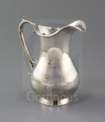 A modern silver cream jug by Rodney C. Pettit, of plain baluster form, with scroll handle, London,