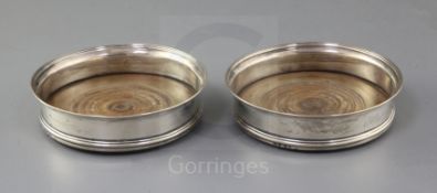 A pair of George III silver wine coasters by Robert Hennell I and David Hennell II, with engraved