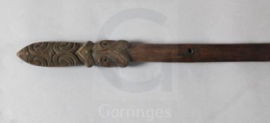 A Maori carved hardwood taiaha staff, New Zealand, with Janus tiki and tapered elliptical shaft,