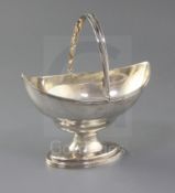 A George III silver boat shaped pedestal sugar basket by Peter & Ann Bateman, with engraved crest
