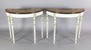 A pair of Adam revival painted and parcel gilt demi lune console tables, with rosewood banded