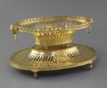 An Edwardian silver gilt dessert basket and stand by William Comyns, the pierced oval basket with