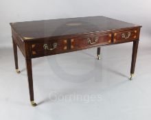 A George III inlaid mahogany writing table, with three frieze drawers on squared tapered legs and