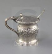 A George V Arts & Crafts silver mustard pot by Omar Ramsden, of cylindrical form with bulbous girdle