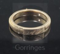 A Victorian milled gold hinged twin compartment mourning band, with engraved monogram, the two