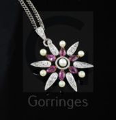 An Edwardian gold and silver, ruby, diamond and seed pearl flower head pendant, on a later silver