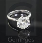 An 18ct white gold and solitaire diamond ring, the round brilliant cut stone approximately just