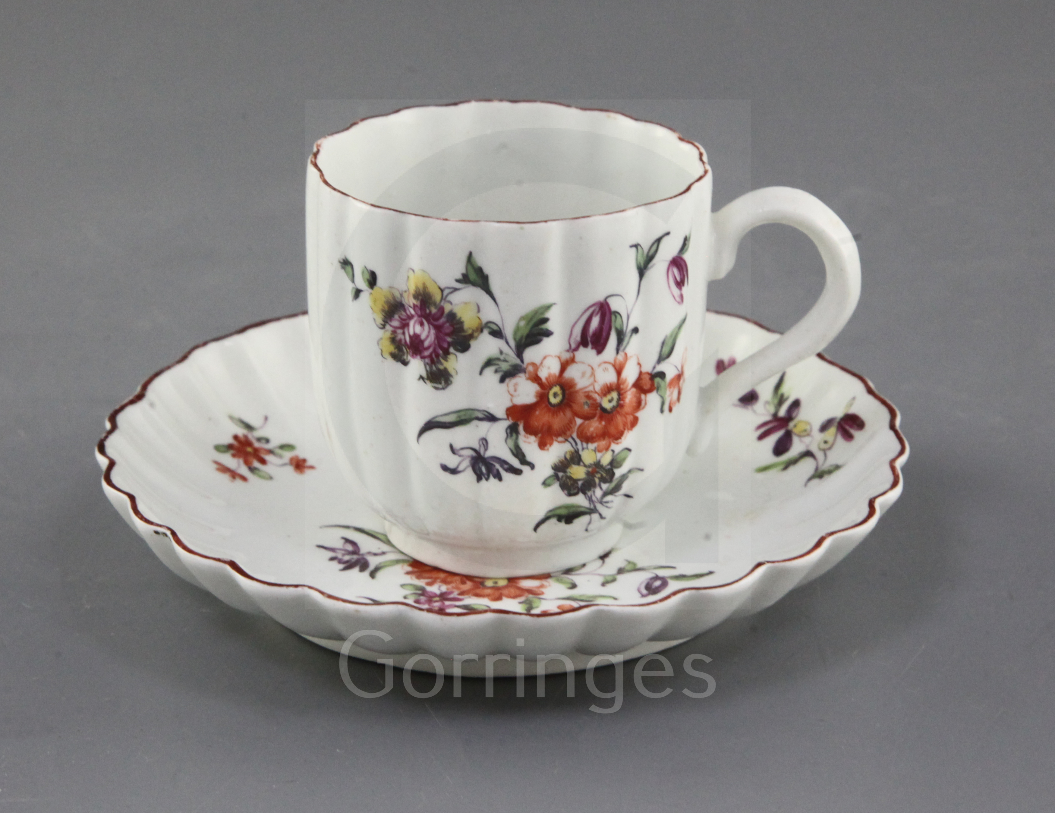 A Derby ribbed coffee cup and saucer, c.1758, each painted in 'Cotton-stem painter' style with a