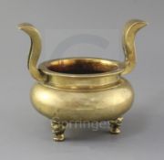 A Chinese bronze ding censer, 19th century, with flying scroll handles, three mask feet, h. 17.