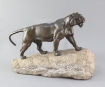 Pierre Granet (1843-1910). A French Art Deco bronze model of a tiger, upon a naturalistic rock base,