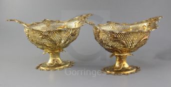 A pair of Edwardian silver gilt oval pedestal dessert baskets, by Herbert Charles Lambert, of boat