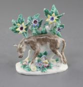 A Bow figure of a wolf, c.1760, standing before a blossoming tree, on a flower encrusted oval