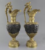 A pair of Renaissance style bronze and ormolu ewers, with cherub capped handles and putti friezes,