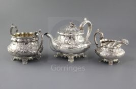 A William IV silver three piece tea set by Joseph & John Angell, of squat form and embossed with