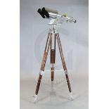 A pair of Nikon 20x120 polished steel and brass Japanese Naval binoculars, with screw focusing to