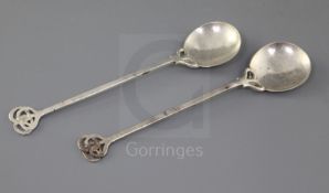 A pair of George V Arts & Crafts silver spoons, by the Keswick School of Industrial Art, with