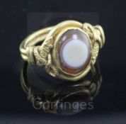 A Roman? gold and banded agate set oval ring, with pierced twin serpent shoulders, size H.