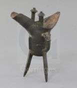 A Chinese archaic bronze wine vessel, Jue, Shang dynasty or later, with a central taotie mask band