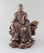 A Japanese wood okimono of the Empress-Consort Jingu seated on a rock, Meiji period, her robes