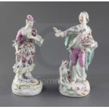 A pair of early Derby figures of a gentleman and his companion, c.1758, each wearing flower