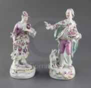 A pair of early Derby figures of a gentleman and his companion, c.1758, each wearing flower