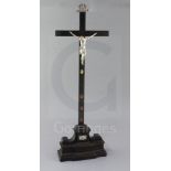 A late 19th century Italian white metal, silvered bronze and ebonised crucifix, the stem of the