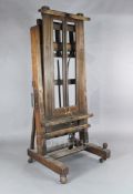A late Victorian mahogany studio easel, with cranked adjustment and brass side handles, W.2ft 8in.