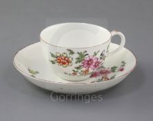 A rare Derby cup and saucer, c.1758, painted in 'Cotton-stem painter' style with a loose bouquet
