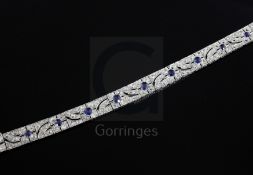 An attractive 1920's pierced white gold, sapphire and diamond bracelet, each link with millegrain