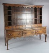 A George III oak dresser, with multi-shelf rack and six spice drawers over three long drawers, on