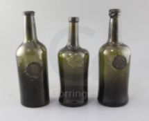 Three black glass mallet shaped wine bottles, two late 18th century, All Souls Common Room sealed